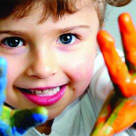 Child with painted hands - Little Friends Nursery